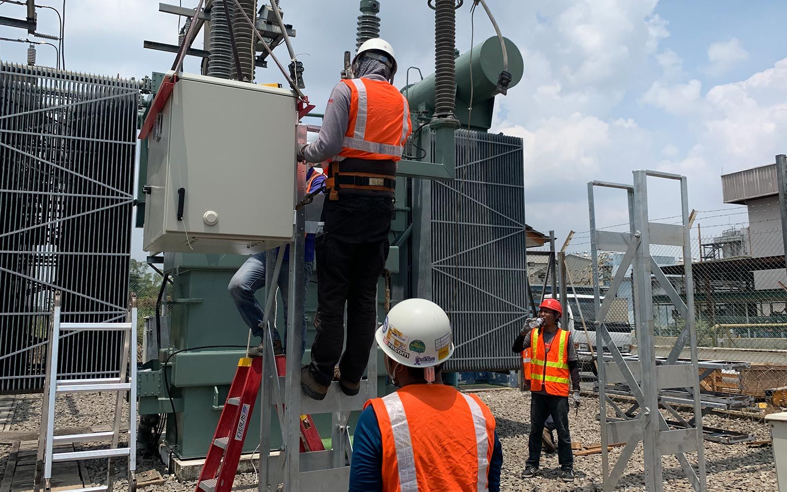 Site team installing electrification equipment